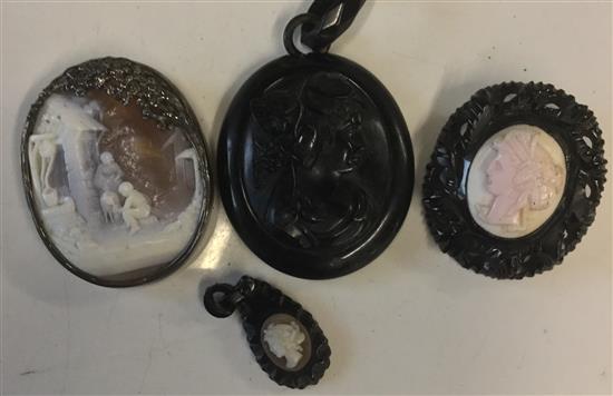 Two gilt-framed oval cameo brooches, a silver-mounted example & three carved jet items (6)